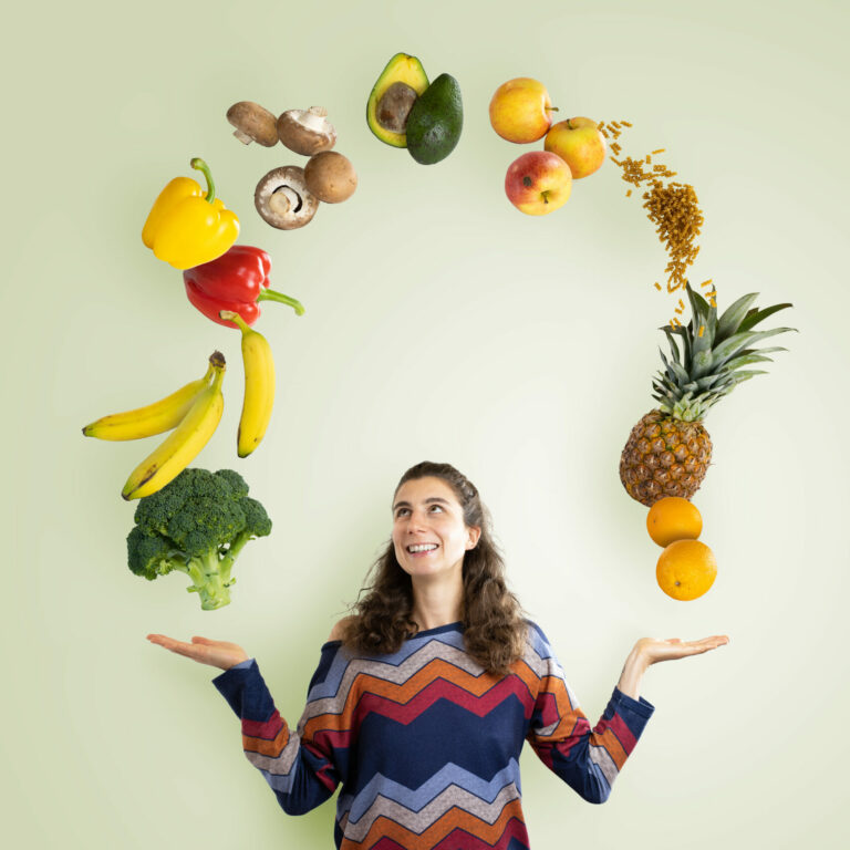 Person with a circle of fruits and veggies